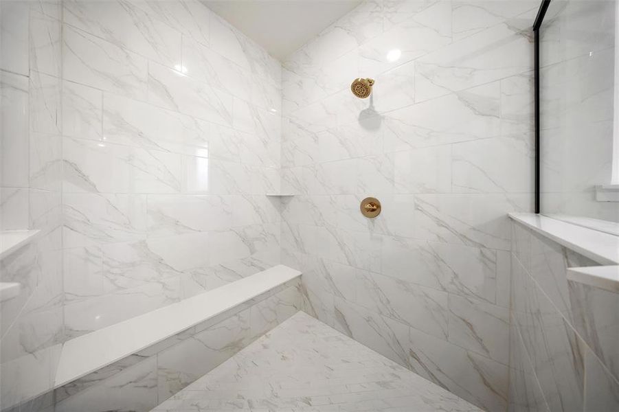 Full bathroom with a marble finish shower