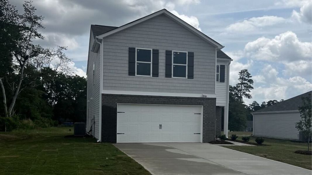 Front exterior of a new home in Hunter Hill, Rocky Mount, NC, highlighting curb appeal (Image 1). Front exterior of a new home in Hunter Hill, Rocky Mount, NC, highlighting curb appeal (Image 1).