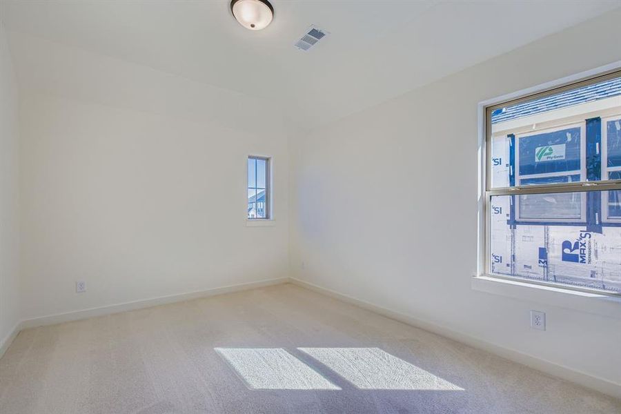 Unfurnished room with light colored carpet and baseboards