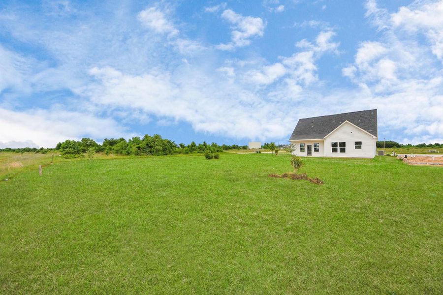 A modern, two-story home with a spacious driveway and a two-car garage. The exterior features a mix of light siding and dark accents, complemented by a neatly landscaped front path. Offering a serene and inviting atmosphere. A modern, two-story home with a spacious driveway and a two-car garage. The exterior features a mix of light siding and dark accents, complemented by a neatly landscaped front path. Offering a serene and inviting atmosphere.