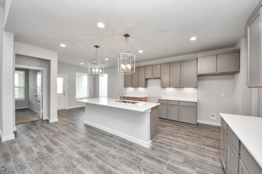 The kitchen is a culinary haven, featuring granite countertops, a tile backsplash, stainless steel appliances, 42” upper cabinets, and undercabinet lighting. The kitchen is a culinary haven, featuring granite countertops, a tile backsplash, stainless steel appliances, 42” upper cabinets, and undercabinet lighting.