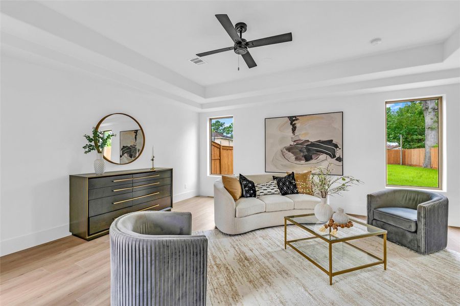 The spacious living room has views of the backyard on one side and views of the courtyard on the other side.