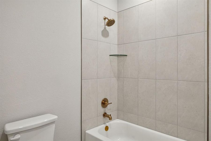 Bathroom featuring toilet and shower / tub combination