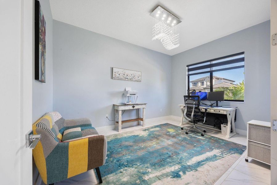 chandelier and marble look tile flooring