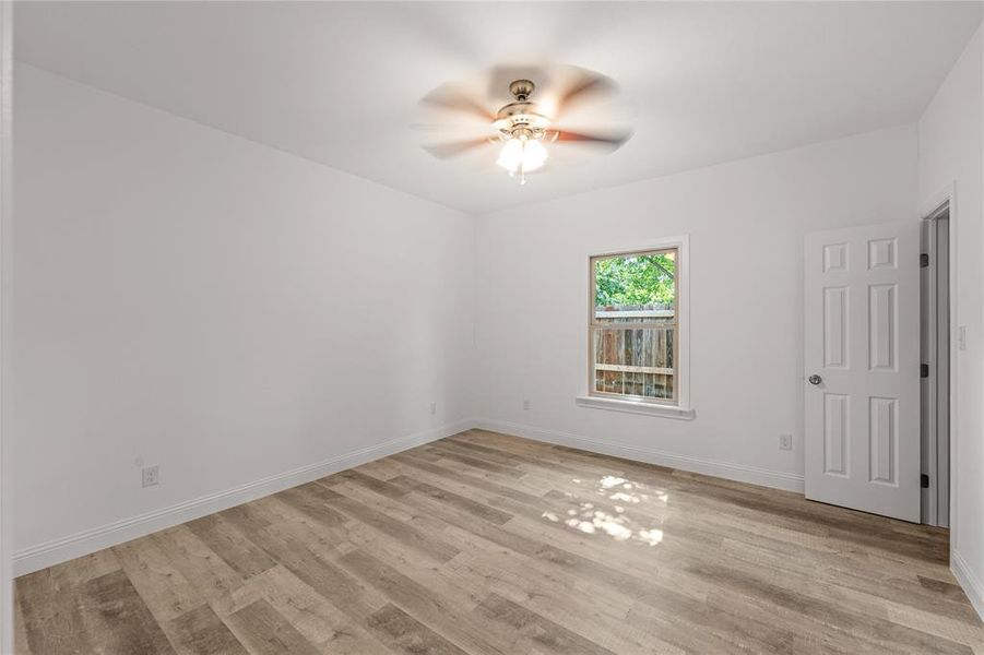 Empty room featuring ceiling fan and light wood-type flooring