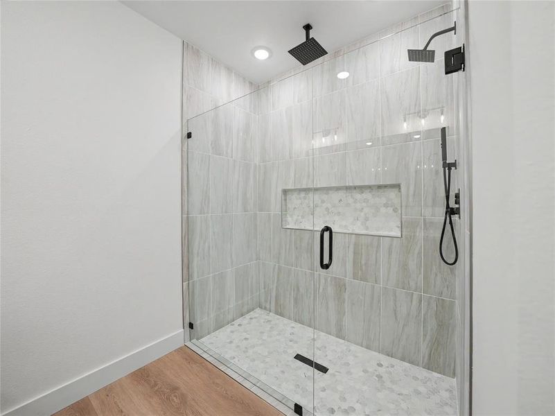 Walk-in shower with clear glass enclosure and matte black hardware Walk-in shower with clear glass enclosure and matte black hardware