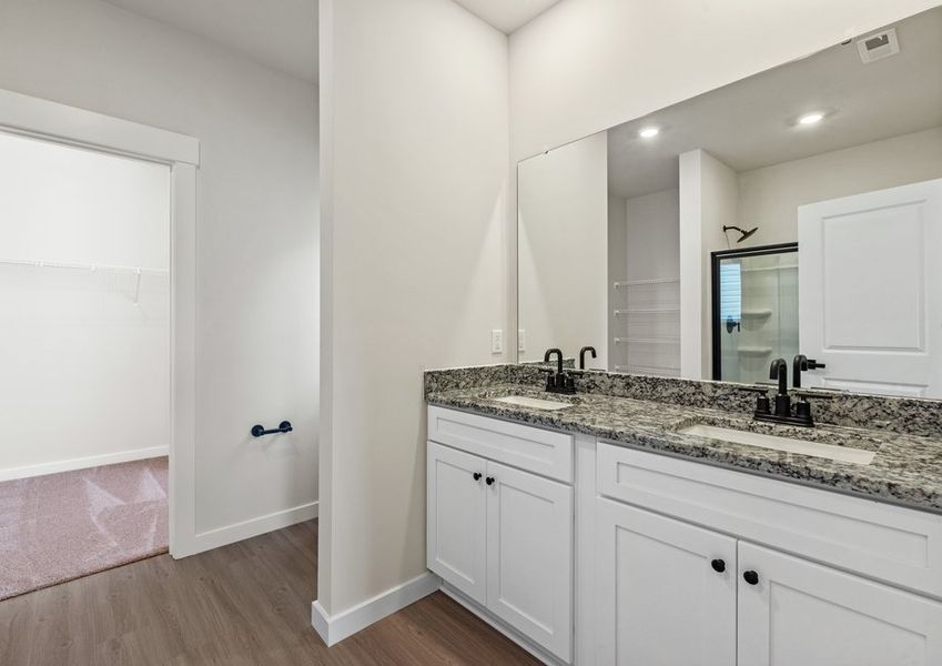 The master bathroom has a glass-enclosed shower