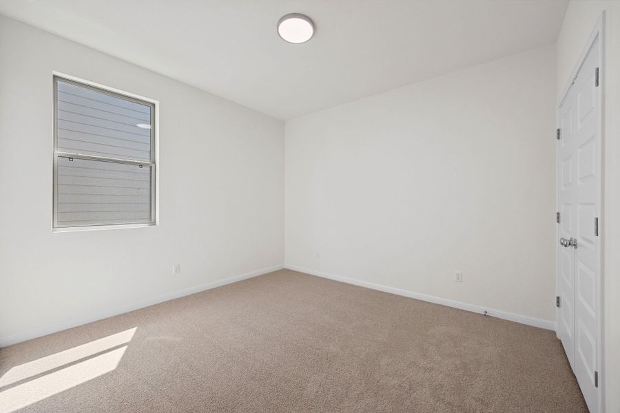 Bedroom in the Elm home plan by Trophy Signature Homes – REPRESENTATIVE PHOTO