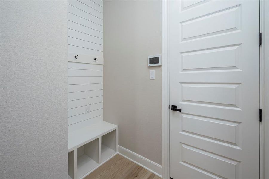 This mud room has cubbies, hooks and outlets in the perfect location for dropping your belongings.