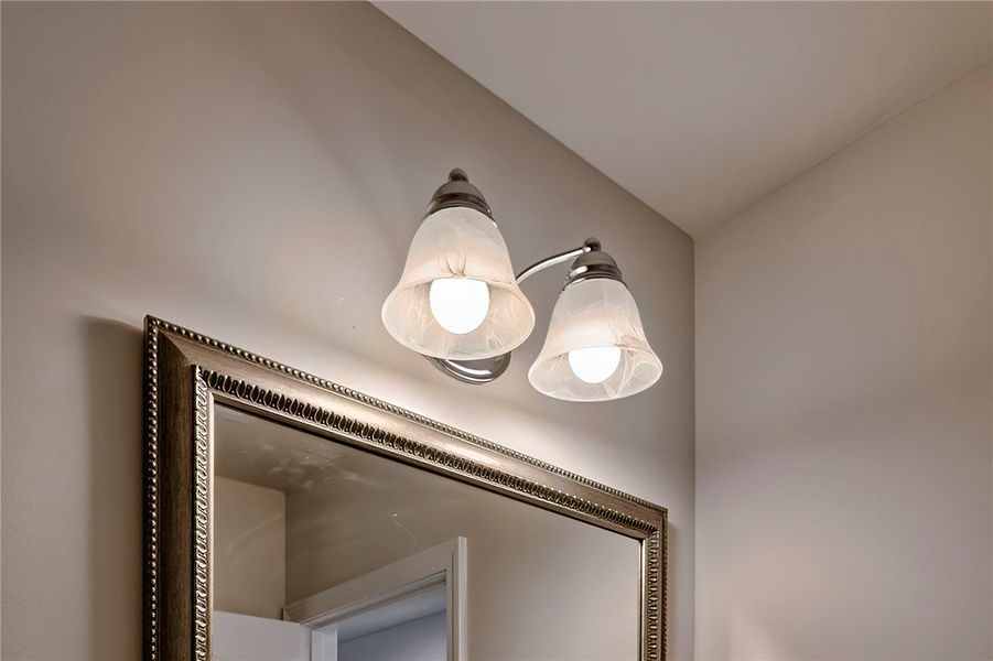 Illuminated mirror with decorative frame enhances