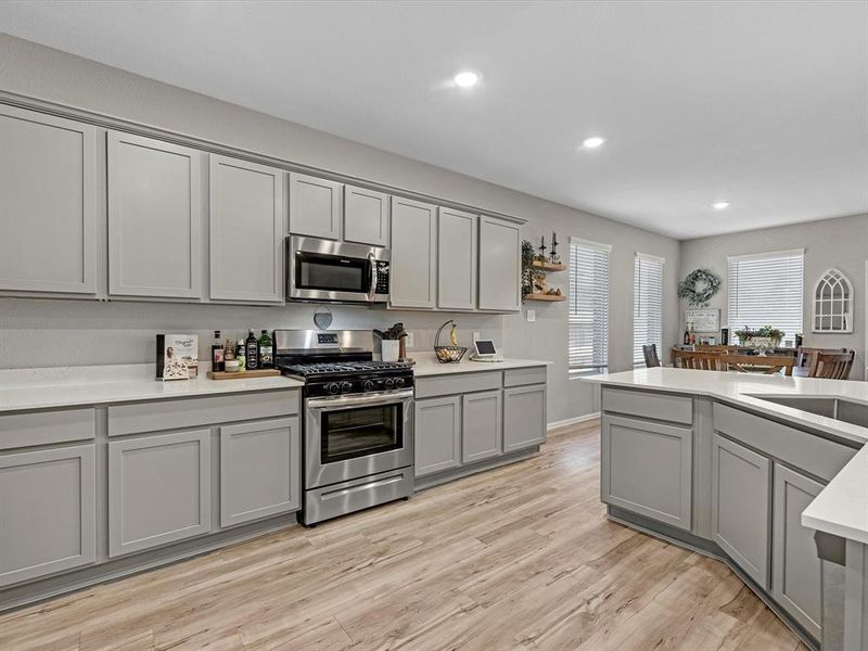 Quartz counters line this light and bright kitchen