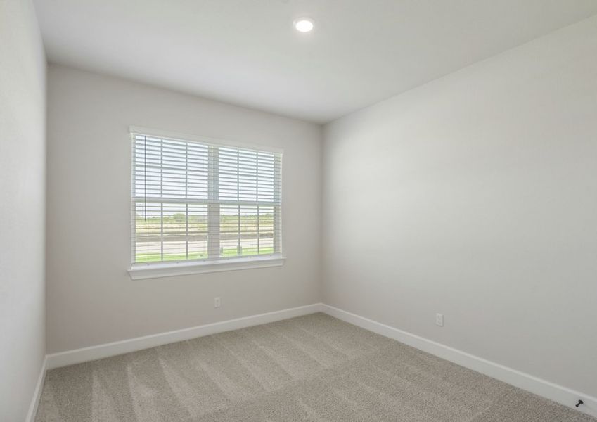 Secondary bedroom with lush carpet flooring