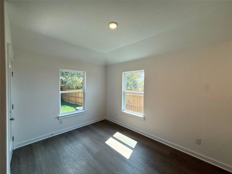 Unfurnished room with baseboards and dark wood-type flooring Unfurnished room with baseboards and dark wood-type flooring