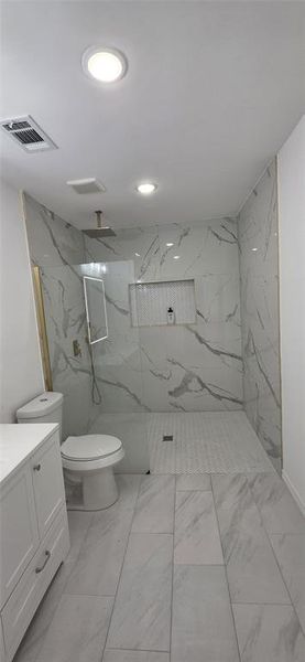 Full bath with a marble finish shower and vanity