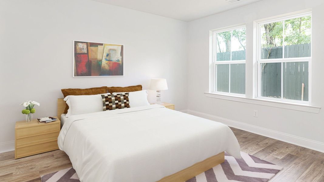 Secondary bedroom with 2 large windows on single wall  in a DRB Homes Brookgreen model home