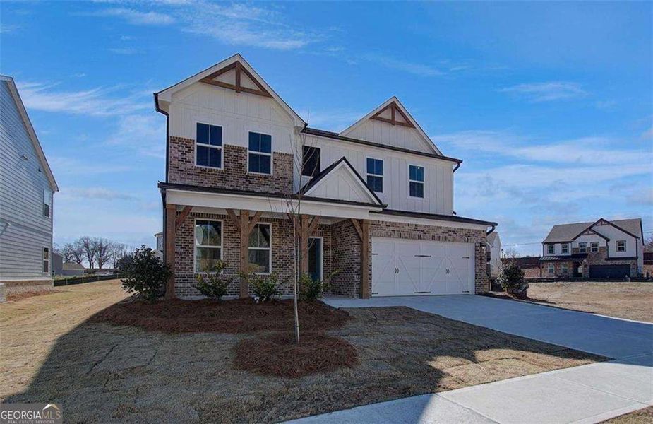 Front exterior of a new home in The Paddocks at Doc Hughes, Buford, GA, highlighting curb appeal (Image 25).
