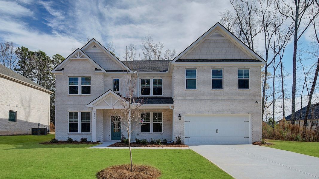 Front exterior of a new home in Cambria at Traditions, Hampton, GA, highlighting curb appeal (Image 2). Front exterior of a new home in Cambria at Traditions, Hampton, GA, highlighting curb appeal (Image 2).