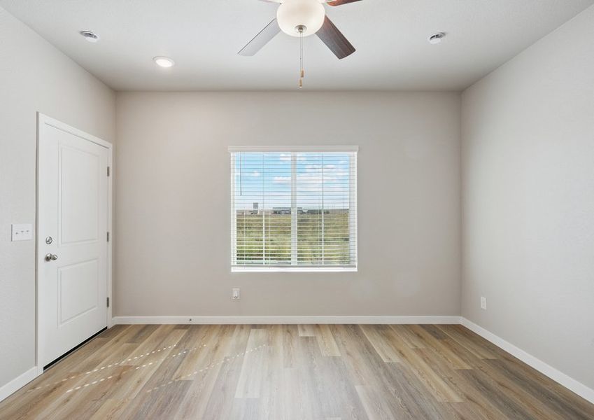The family room is spacious with a ceiling fan.