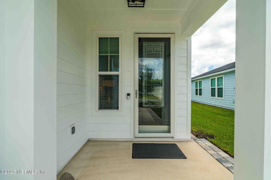 Front exterior of a new home in Summer Bay at Grand Oaks, St. Augustine, FL, highlighting curb appeal (Image 21). Front exterior of a new home in Summer Bay at Grand Oaks, St. Augustine, FL, highlighting curb appeal (Image 21).