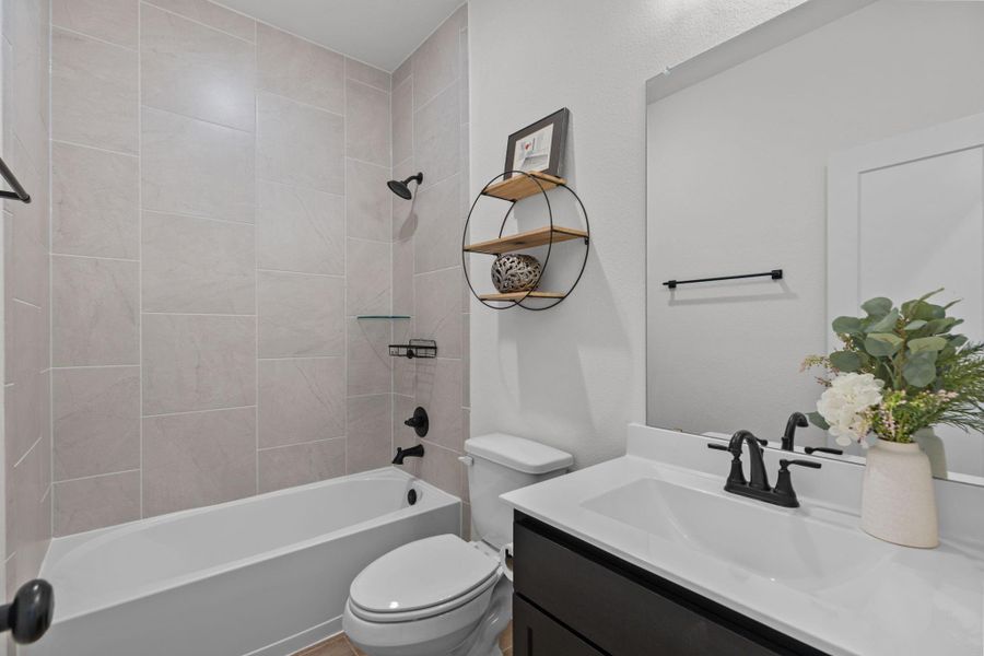 Pretty second full bathroom with tub / shower combination.