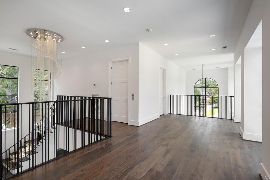 Graceful and expansive second-floor landing, offering a refined transition between living spaces with abundant natural light and sophisticated architectural details.