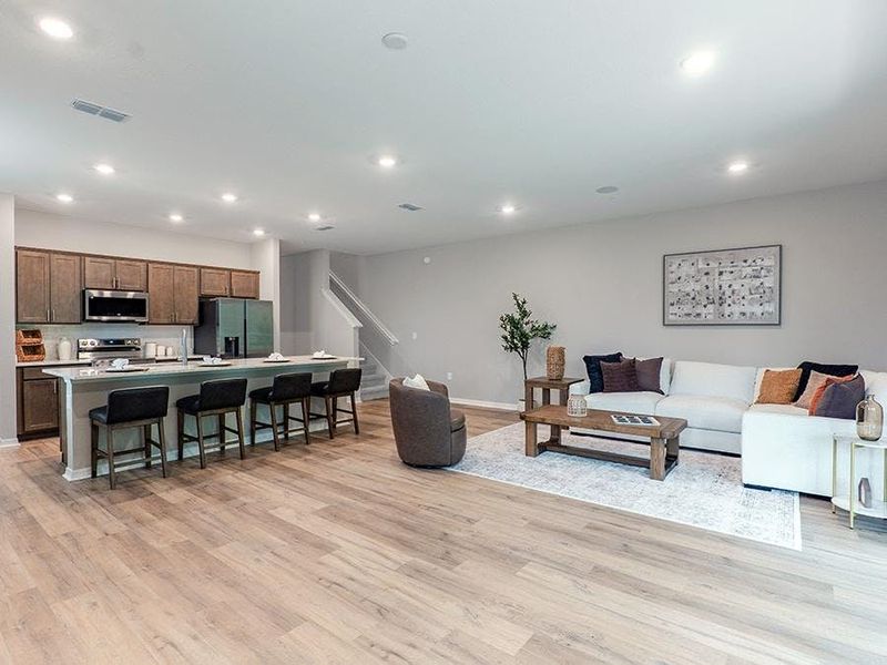 Downstairs, enjoy a spacious and open living area - Birch townhome by Highland Homes Downstairs, enjoy a spacious and open living area - Birch townhome by Highland Homes