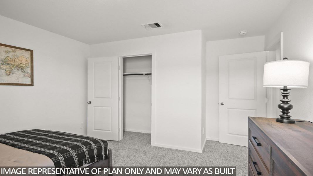 Bedroom with light carpet and a closet