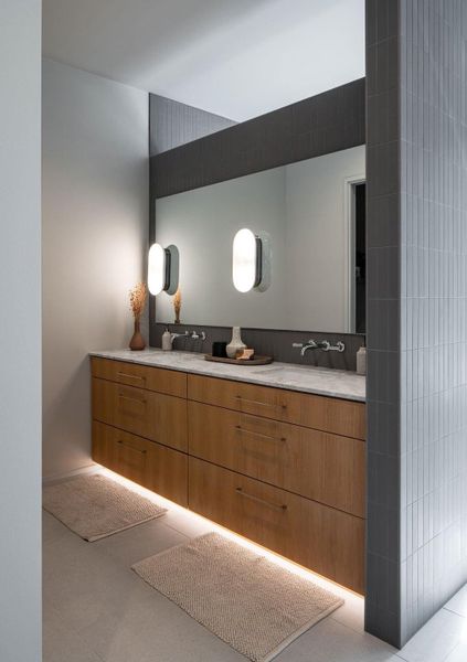 Amazing white oak vanity with gorgeous dolomite countertops and luxury lighting and tile.