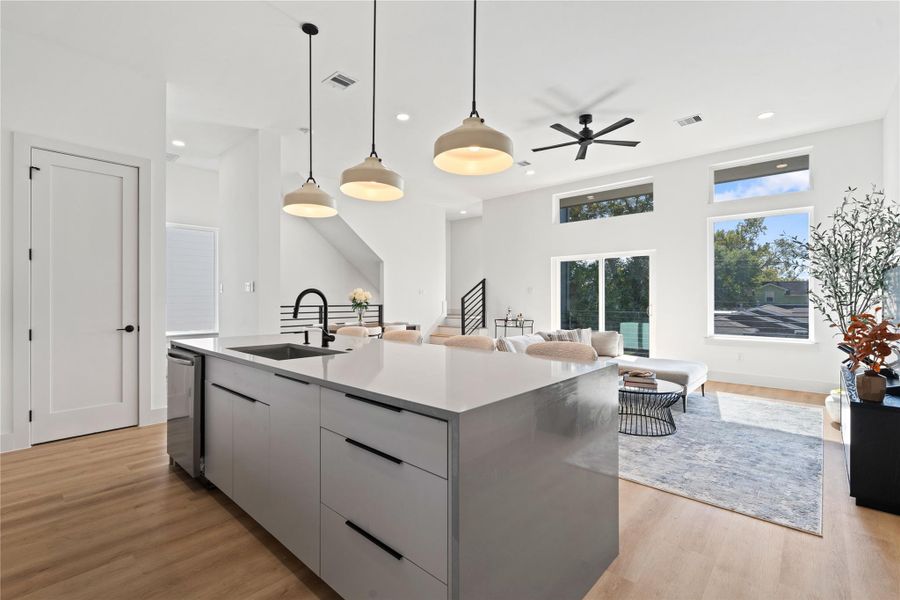 A seamless connection between kitchen, living, & dining, enhanced by expansive picture windows & access to the covered balcony. A seamless connection between kitchen, living, & dining, enhanced by expansive picture windows & access to the covered balcony.