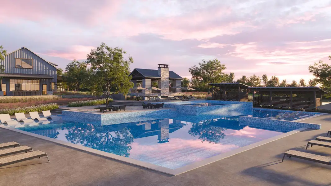 Pool at dusk with a patio and a pool with connected hot tub