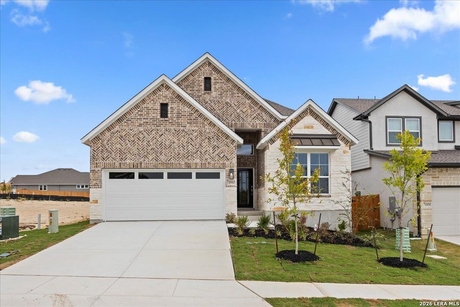 Front exterior of a new home in Meyer Ranch 45's, New Braunfels, TX, highlighting curb appeal (Image 2). Front exterior of a new home in Meyer Ranch 45's, New Braunfels, TX, highlighting curb appeal (Image 2).