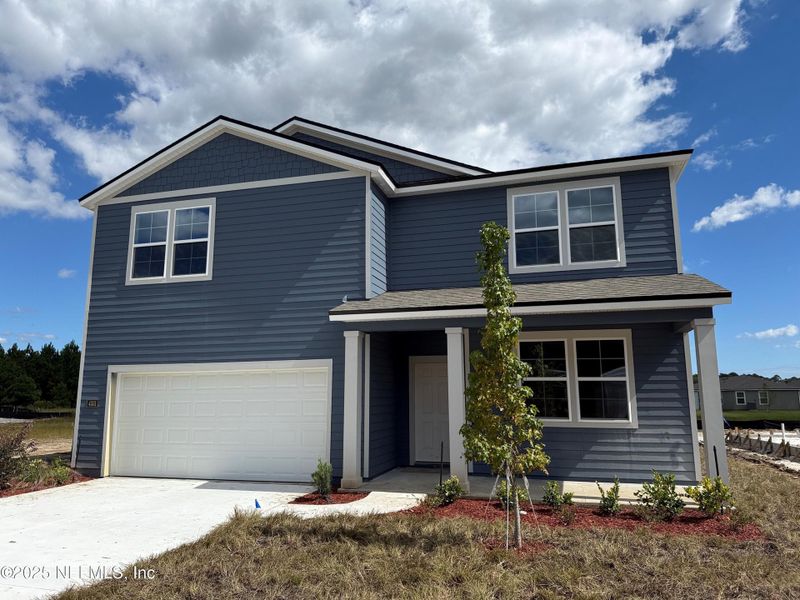 Front exterior of a new home in The Arbors, Jacksonville, FL, highlighting curb appeal (Image 30). Front exterior of a new home in The Arbors, Jacksonville, FL, highlighting curb appeal (Image 30).