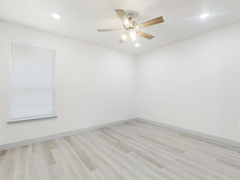 Spare room featuring light wood-type flooring, recessed lighting, and a ceiling fan