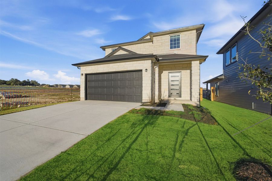 Front exterior of a new home in Cool Water, Jarrell, TX, highlighting curb appeal (Image 2).