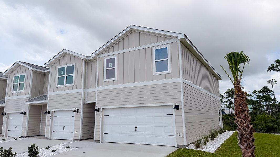 Front exterior of a new home in WindMark Beach, Port Saint Joe, FL, highlighting curb appeal (Image 24).