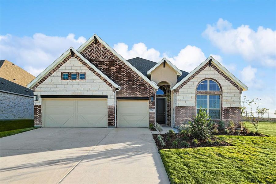 Kitchen featuring vaulted ceiling, light stone countertops, white cabinets, stainless steel appliances, and dark wood finished floors Kitchen featuring vaulted ceiling, light stone countertops, white cabinets, stainless steel appliances, and dark wood finished floors