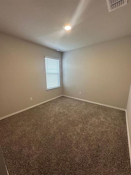 Spare room featuring carpet floors and a textured ceiling