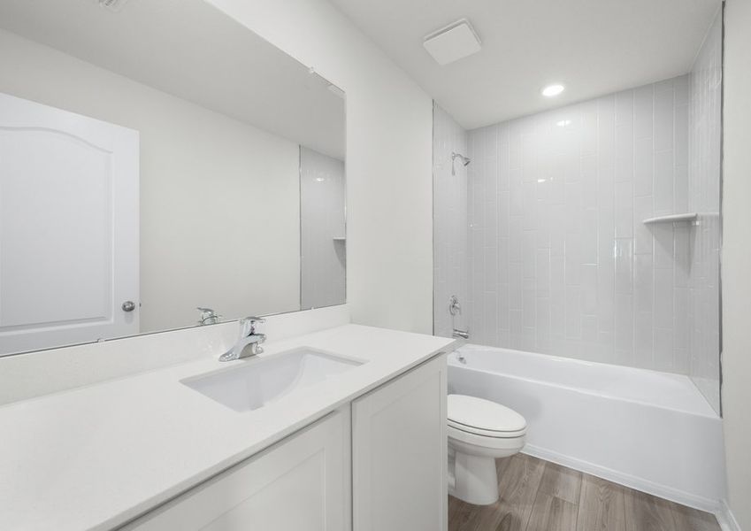 This secondary bathroom features a beautifully tilted shower