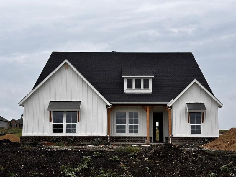 Modern farmhouse exterior featuring white board and batten siding