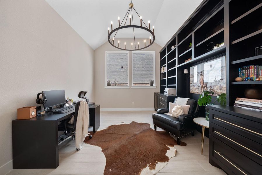 The office with a custom-built black shelving unit provides ample storage and display space, keeping everything organized while adding a touch of elegance to the room. The office with a custom-built black shelving unit provides ample storage and display space, keeping everything organized while adding a touch of elegance to the room.