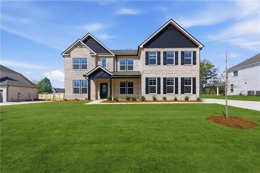 Front exterior of a new home in Cambria at Traditions, Hampton, GA, highlighting curb appeal (Image 1). Front exterior of a new home in Cambria at Traditions, Hampton, GA, highlighting curb appeal (Image 1).