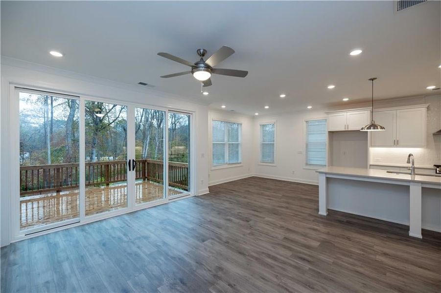 From family room view, sliding door will be 8ft. and will feature a covered patio with fenced in backyard. Pictures represent a previously built home not the actual home, home is under construction.