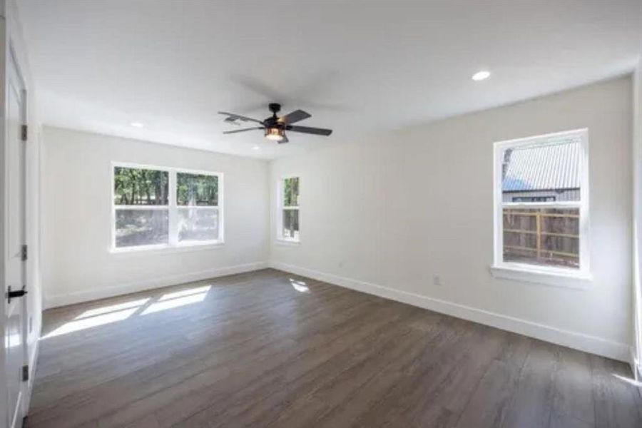 Spare room featuring dark wood-style floors, recessed lighting, and ceiling fan