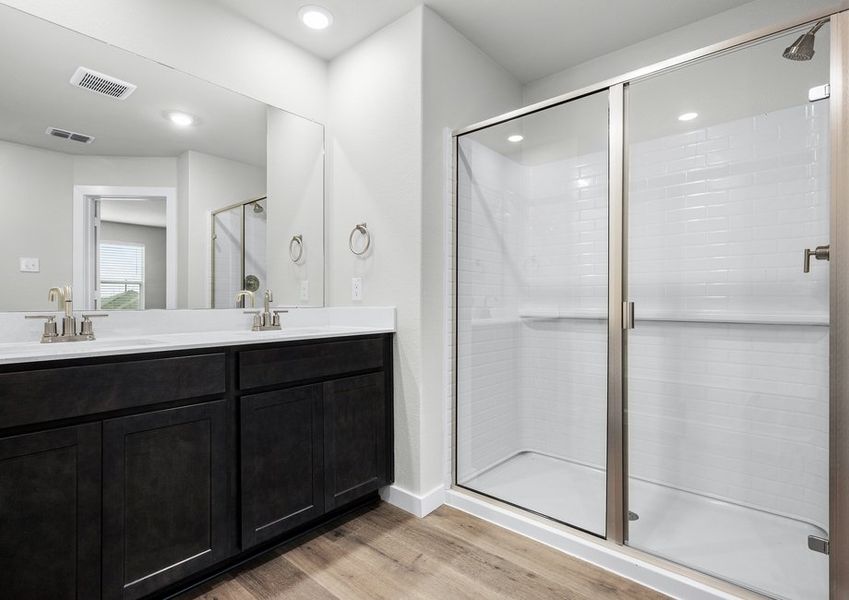 The master bathroom has a sprawling vanity and glass, walk-in shower. The master bathroom has a sprawling vanity and glass, walk-in shower.