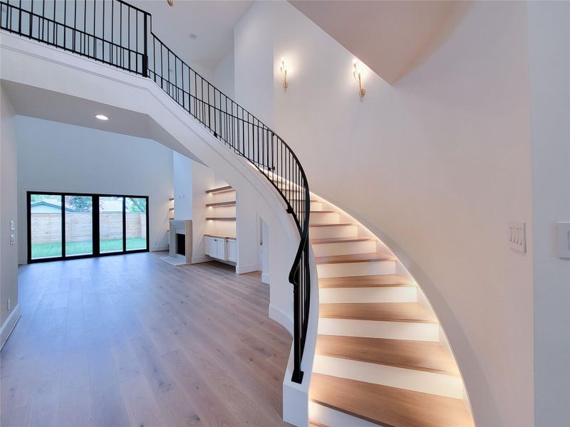 Spiral staircase serves as a stunning architectural focal point, featuring integrated hidden LED lighting that accentuates its elegant design. Spiral staircase serves as a stunning architectural focal point, featuring integrated hidden LED lighting that accentuates its elegant design.