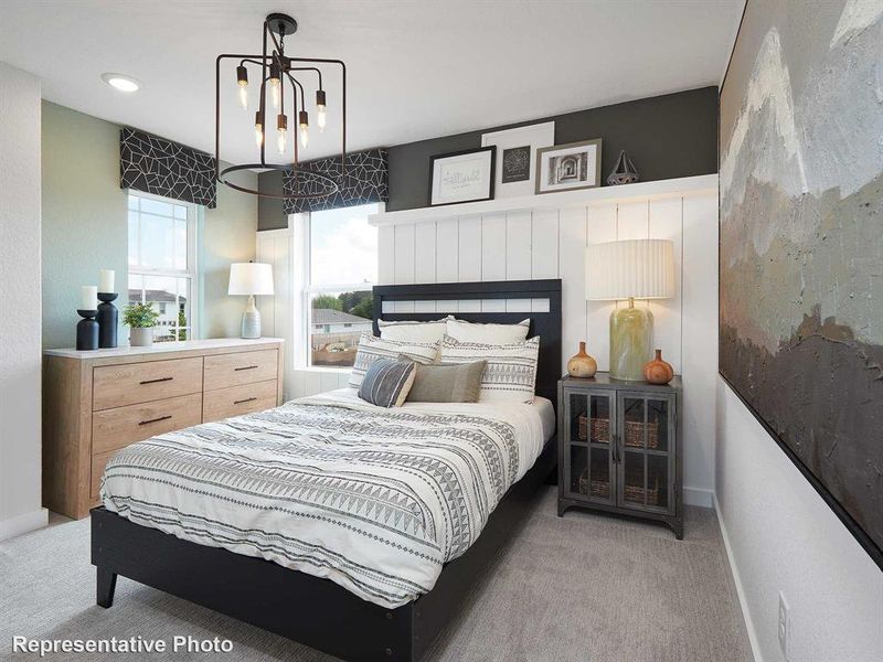 This room features two windows with patterned blinds, a contemporary light fixture, and carpeting