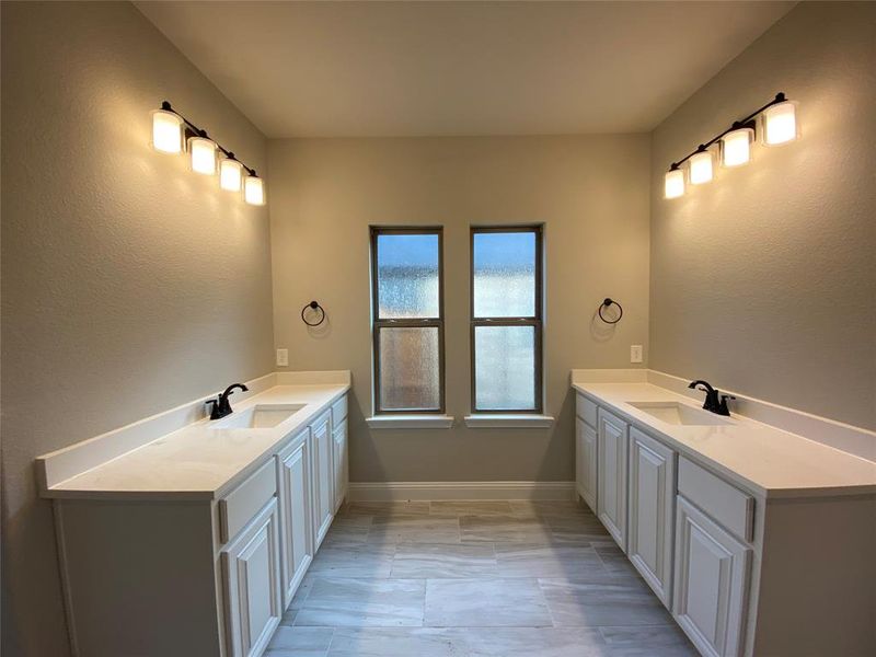 His & her vanities with quartz countertops & ORB fixtures (mirrors not intalled yet)