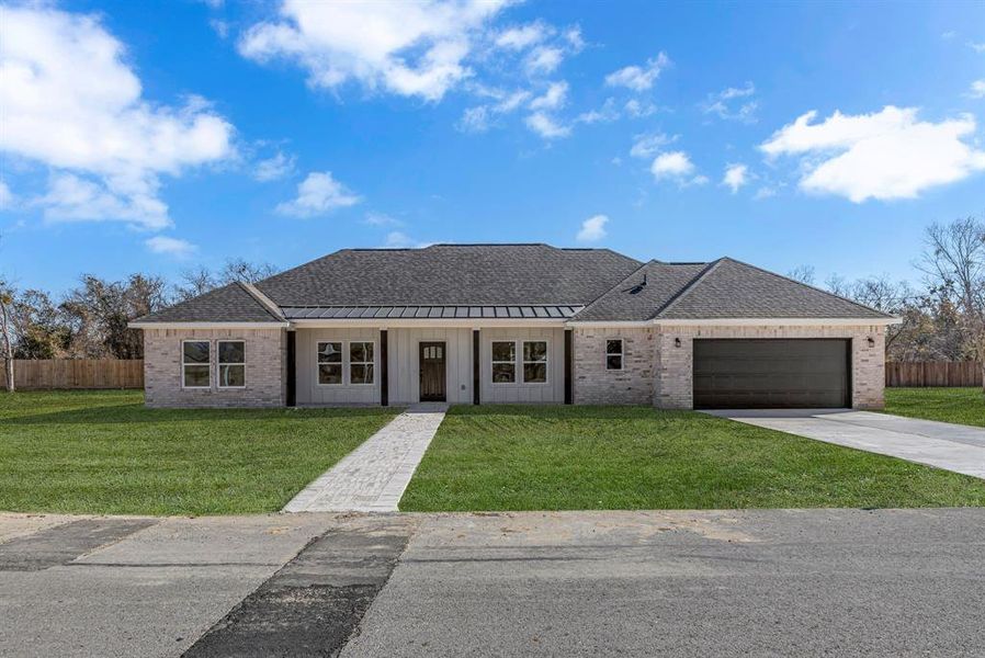 Ranch-style house with a garage and a front yard