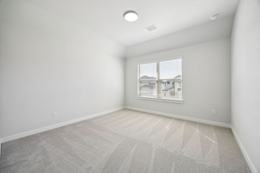 Bedroom in the Wimbledon home plan by Trophy Signature Homes – REPRESENTATIVE PHOTO
