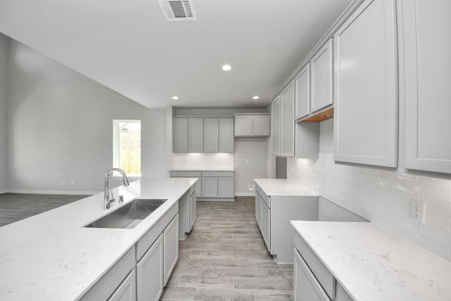 The kitchen is a culinary haven, featuring granite countertops, a tile backsplash, stainless steel appliances, 42” upper cabinets, and undercabinet lighting. The kitchen is a culinary haven, featuring granite countertops, a tile backsplash, stainless steel appliances, 42” upper cabinets, and undercabinet lighting.